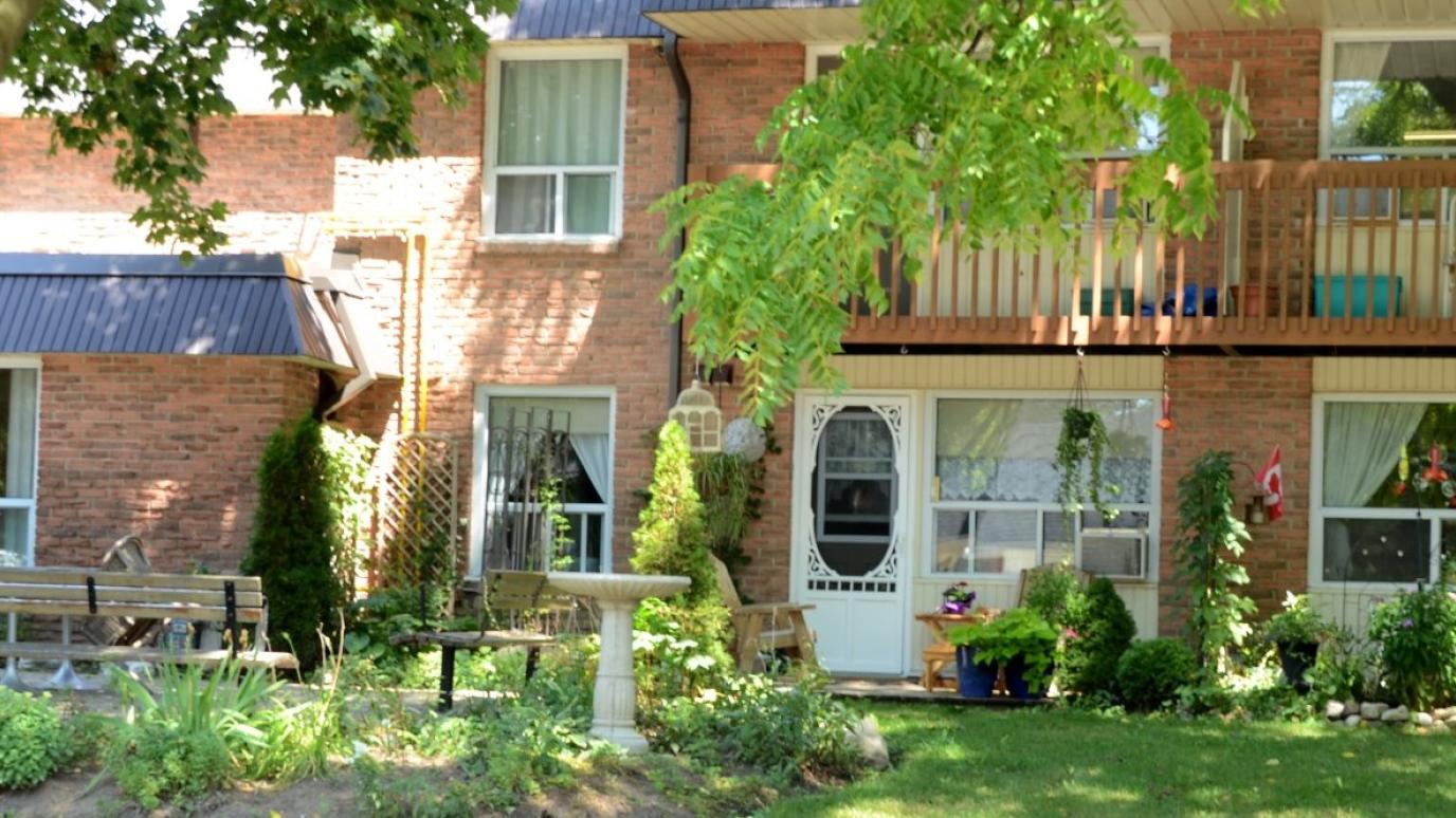 The exterior of 221 Mary Street, Elora, with a garden in front.
