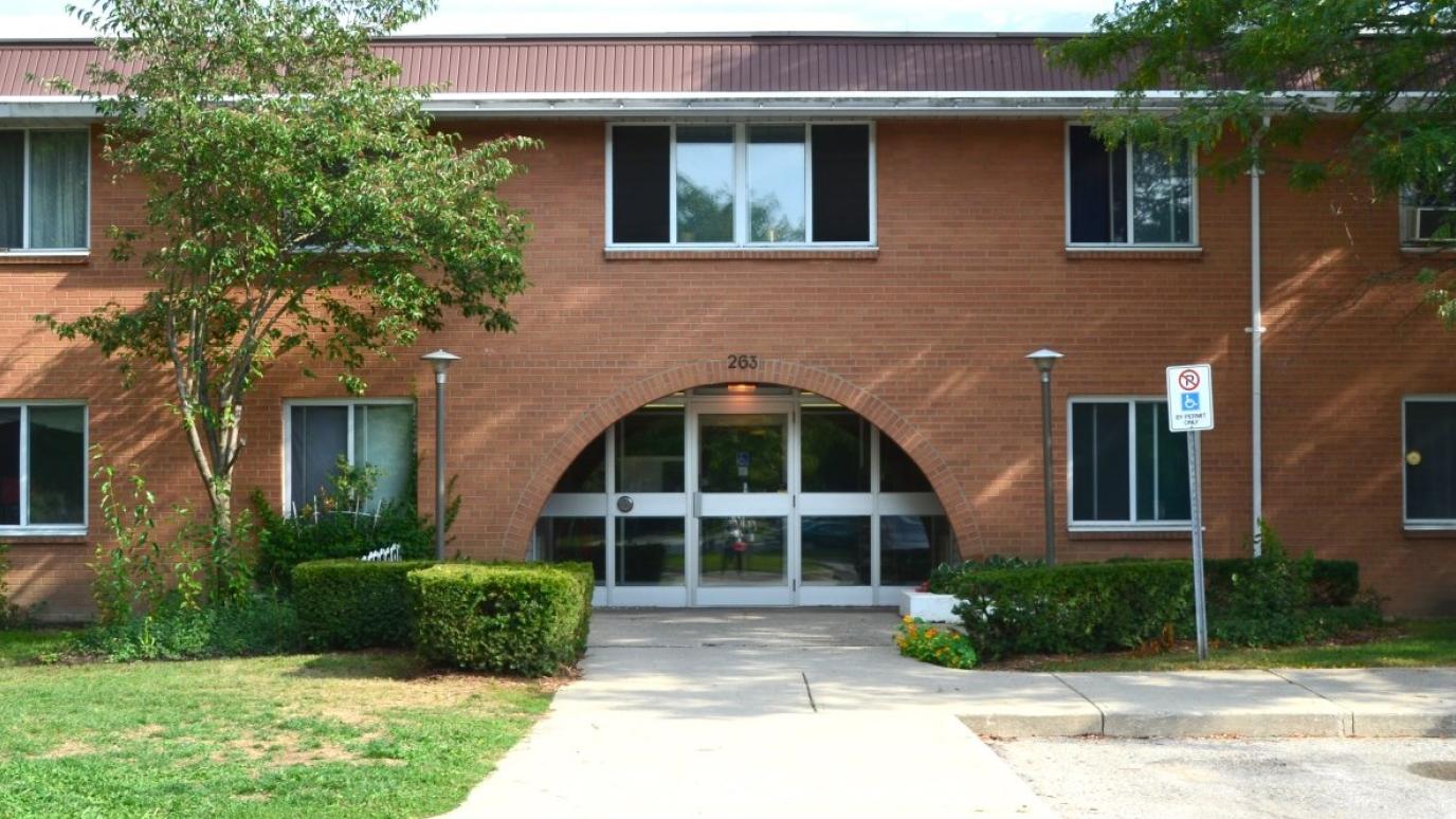 Exterior of Speedvale Avenue East, Guelph. A two-storey apartment building, looking towards the entranceway.