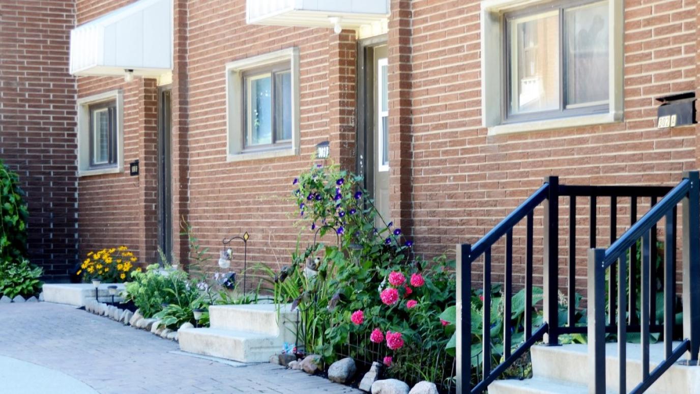 Exterior of 301-303 Edinburgh Avenue, Fergus. It is a red brick row townhouse.