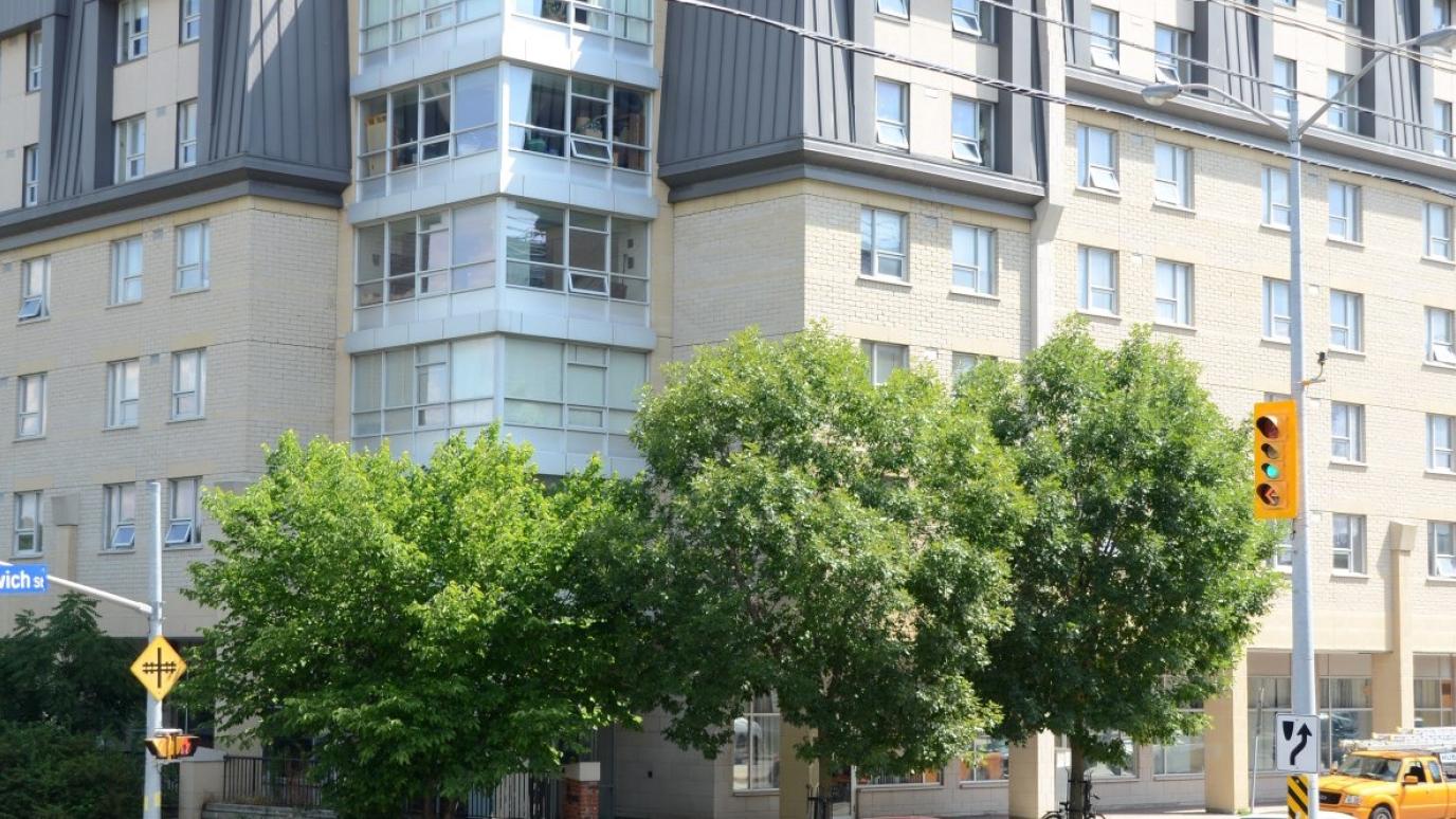 Exterior of 141 Woolwich Street, Guelph. It is a 6-storey apartment building on a street corner.