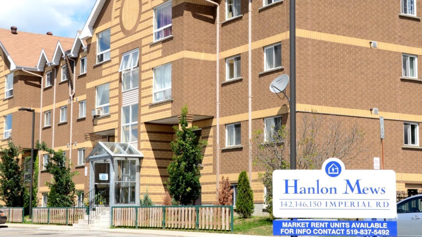 Exterior of the building, with the sign "Hanlon Mews" in front.