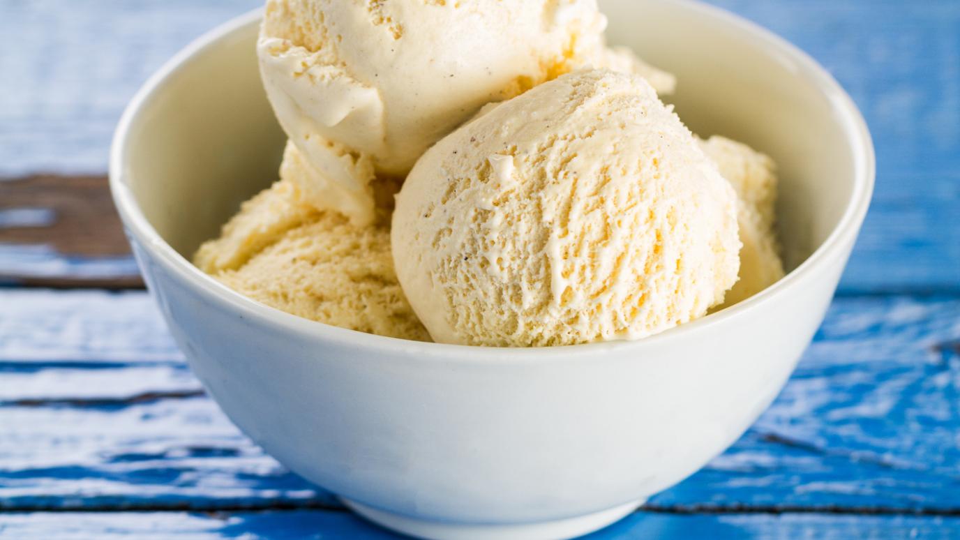 vanilla ice cream scoops in a white bowl