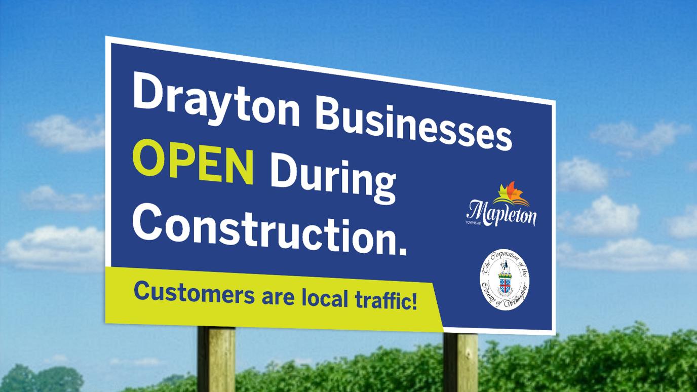 A roadside sign that reads "Drayton Businesses OPEN During Construction. Customer are local traffic!"