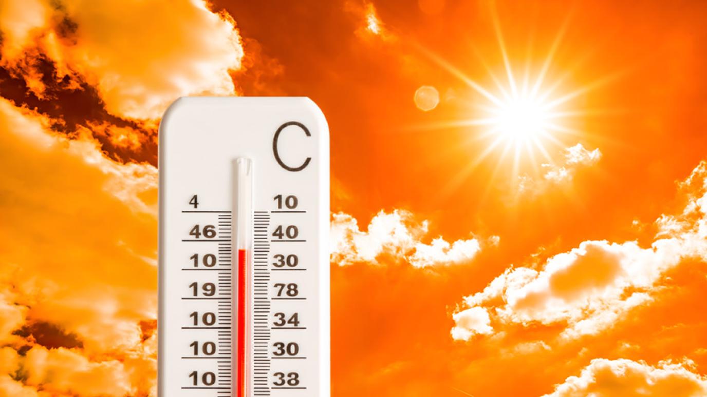 A very hot sunny sky in the background with a thermometer reading a high temperature in front of it.
