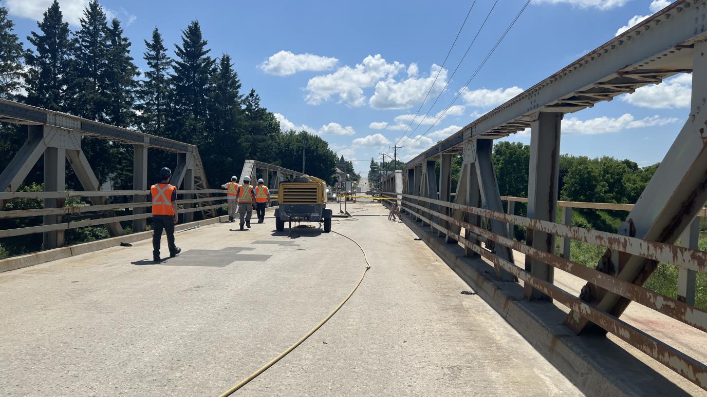 Top of bridge with construction crews and generator.