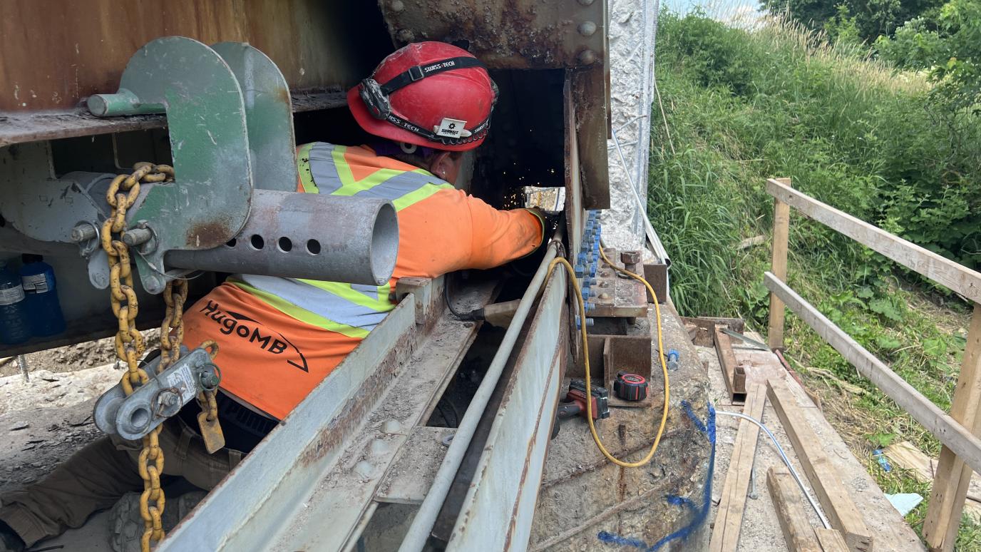 Construction worker working on bridge structure.
