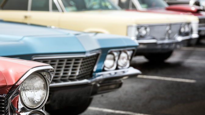 Vintage cars parked in a parking lot