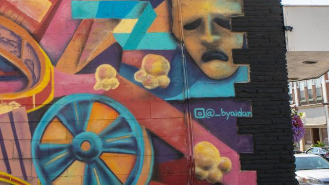 Colourful theatrical mural on the side of a building downtown Minto