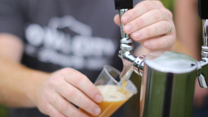 Person pouring draft beer
