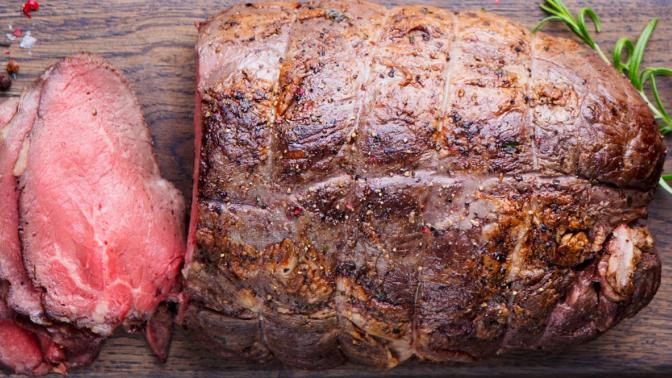 beef roast sliced on a cutting board