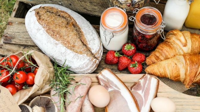 bread, fruit and jam on a board