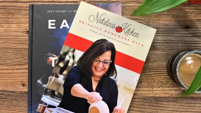 cookbooks sitting on table with coffee and plant