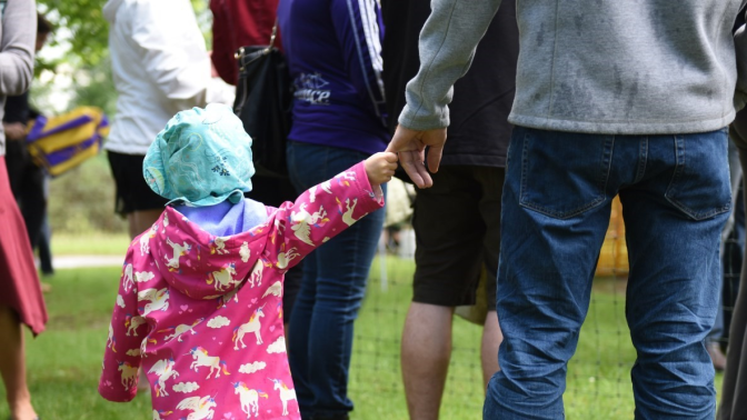 Little girl and dad holding hands