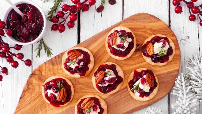 Mini cranberry appetizers appetizers displayed on a rustic wooden board 