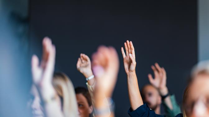 Hands in the air at a seminar