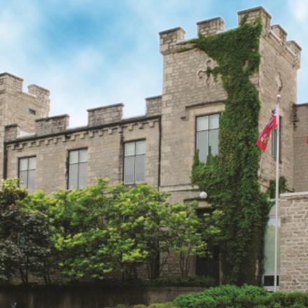 County of Wellington Administration Building with green vines climbing the stone.