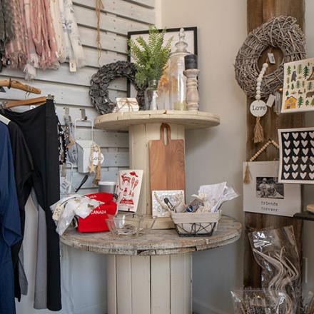 Clothing and gift items displayed on the wall in a small shop