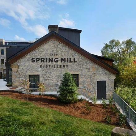Exterior brick facade of the historic Spring Mill next to the river downtown Guelph