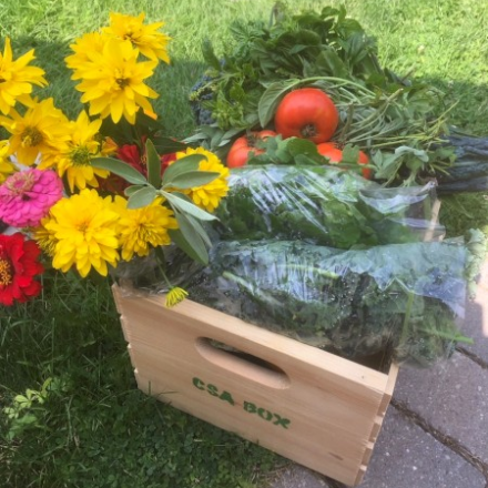 crate of produce and flowers