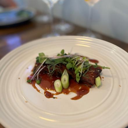 pork ends in a ginger sauce on plate