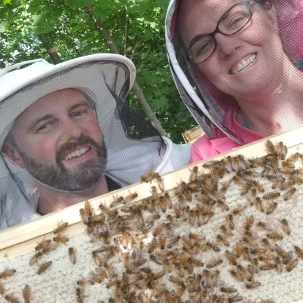 two people with bees