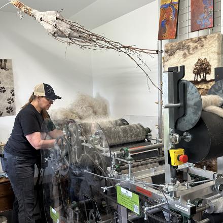 person running wool processing machine