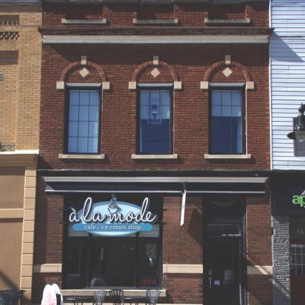 outside of a coffee shop downtown with seating