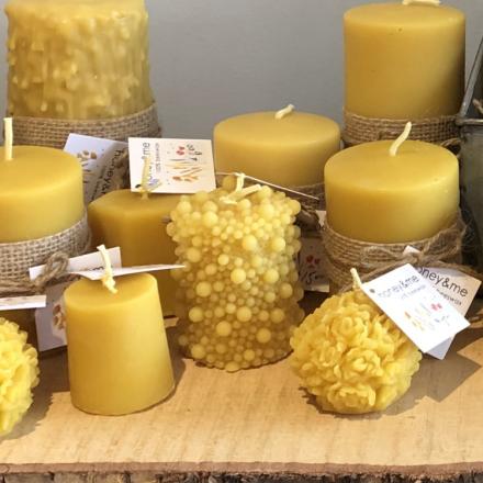various beeswax candles on a wooden board
