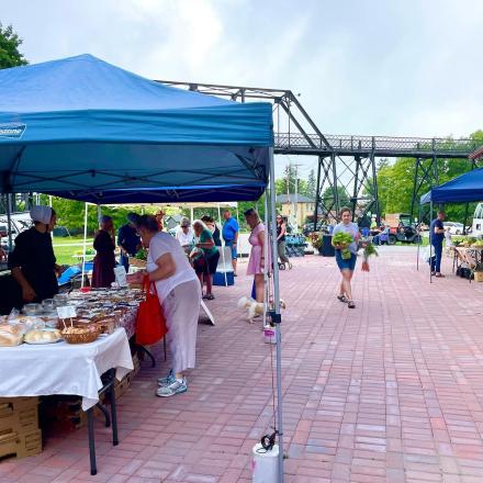 market tent booths set up near railway bridge