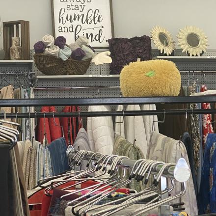 clothes on hangers inside Mission Thrift