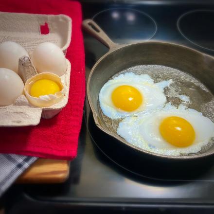 cracked eggs in a frying pan