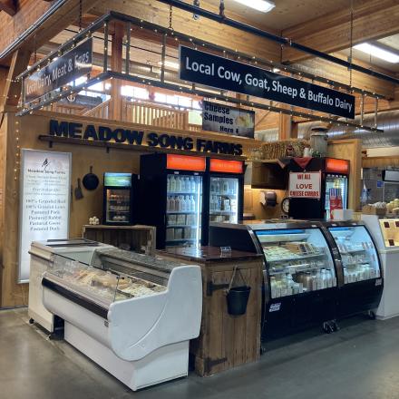 farm products displayed in fridge cases at a market