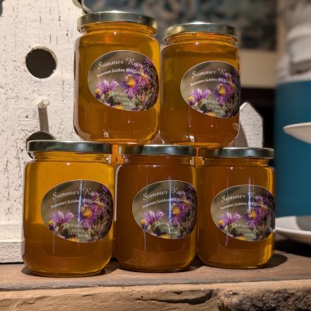 jars of golden honey stacked on top of each other