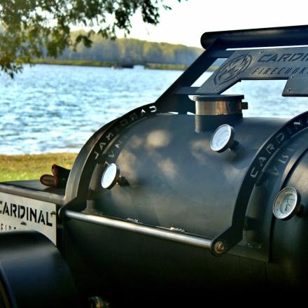 close up of a black cooker with water in the background