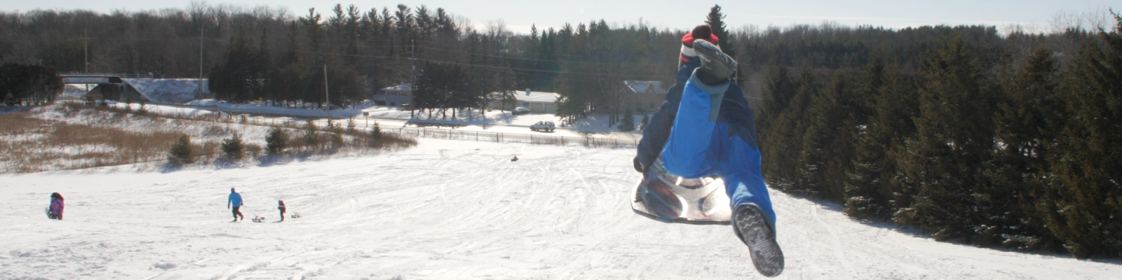 person sledding down a hill