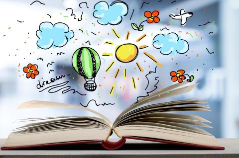 An open book with hand drawn illustrations of clouds and suns popping out of it. 