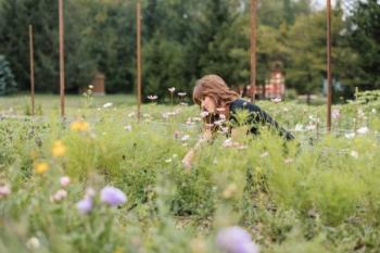 A woman tending to flowers on a farm.