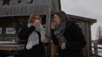 two individuals eating and drinking cafe and bakery goods