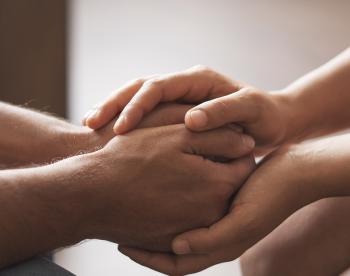 Close up of two people holding hands