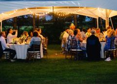 patrons sitting under a tent with lights