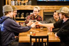 group of people sitting at harvest table cheersing