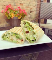 sandwich wrap on plate with lettuce, chicken and more