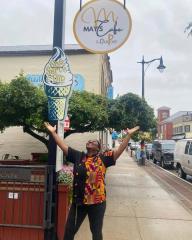 person standing under cafe sign in from of outdoor patio downtown Harriston