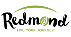 A business logo which reads "Redmond". The "o" is a green leaf. Underneath is a caption: "Live your journey". Above the text is a green arch.