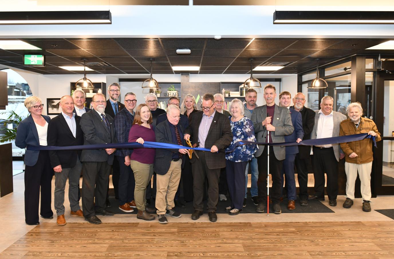 A group of people cutting a ribbon