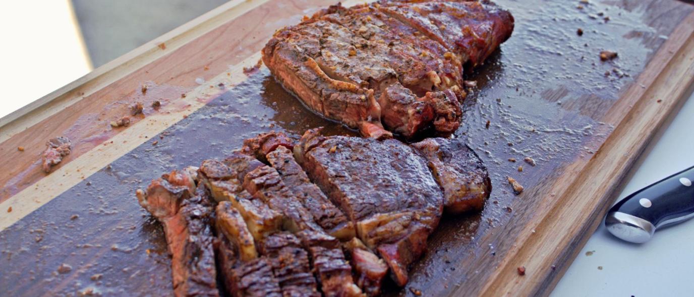Close up of juicy barbecued meat on a cutting board